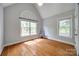 Bright bedroom featuring hardwood floors, a vaulted ceiling, and two windows overlooking the property at 2470 Highway 557 Rd, Clover, SC 29710