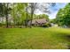 Well-manicured lawn and landscaped front yard lead to a charming brick home with a long driveway at 2470 Highway 557 Rd, Clover, SC 29710