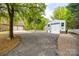 View of detached garages with parking, landscaping, and pool in the background at 2470 Highway 557 Rd, Clover, SC 29710
