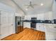 Bright kitchen featuring white cabinets, stainless steel appliances, and hardwood floors at 2470 Highway 557 Rd, Clover, SC 29710