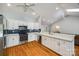 Bright kitchen showcasing white cabinetry, stainless steel appliances, hardwood floors, and modern finishes at 2470 Highway 557 Rd, Clover, SC 29710
