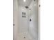 White tiled shower with a rainfall showerhead and niche for storing bath products at 2470 Highway 557 Rd, Clover, SC 29710