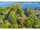 Aerial view of the property and neighborhood surrounded by trees and blue water at 252 Greyfriars Rd, Mooresville, NC 28117