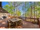 Inviting deck with wood table and chairs overlooking a scenic lake, perfect for outdoor entertaining at 252 Greyfriars Rd, Mooresville, NC 28117