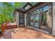 Backyard featuring a large deck, multiple entry points, and lush greenery at 252 Greyfriars Rd, Mooresville, NC 28117