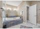 Bathroom featuring a large soaking tub with custom tile surround and modern fixtures at 252 Greyfriars Rd, Mooresville, NC 28117