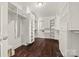 Spacious walk-in closet with custom shelving and ample storage space and hardwood floor at 252 Greyfriars Rd, Mooresville, NC 28117