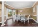 Elegant dining room with a large bay window, hardwood floors, and stylish chandelier at 252 Greyfriars Rd, Mooresville, NC 28117