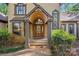 A grand entrance with stone pillars, arched doorway and natural wood door create an impressive facade at 252 Greyfriars Rd, Mooresville, NC 28117