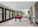 Spacious game room with a pool table, walkout, and carpeted flooring at 252 Greyfriars Rd, Mooresville, NC 28117