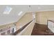 Hallway with hardwood floors, staircase with wood railing, and skylights at 252 Greyfriars Rd, Mooresville, NC 28117