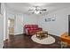 Living room with hardwood floors, ceiling fan, and a red leather sofa at 252 Greyfriars Rd, Mooresville, NC 28117