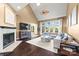 Bright living room featuring a fireplace, large windows, vaulted ceilings, and a comfortable sectional at 252 Greyfriars Rd, Mooresville, NC 28117