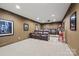 Home theater room equipped with leather reclining chairs, a projector, and movie decor at 252 Greyfriars Rd, Mooresville, NC 28117