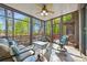 Cozy sunroom with scenic outdoor views, comfortable seating, and a ceiling fan at 252 Greyfriars Rd, Mooresville, NC 28117