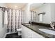 Bright bathroom with double sinks, granite countertop, modern vanity, and a shower with a stylish curtain at 2676 Poplar Cove Nw Dr, Concord, NC 28027