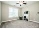 Cozy bedroom features a large window, neutral decor, and soft carpet at 2676 Poplar Cove Nw Dr, Concord, NC 28027