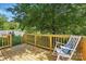 Enjoy this spacious wooden back deck, with railings and a relaxing rocking chair at 2945 Christian Scott Ln, Charlotte, NC 28214