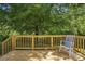 Relax on the wooden back deck, with a view of the lush backyard and mature trees at 2945 Christian Scott Ln, Charlotte, NC 28214