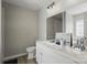 Bathroom featuring double sinks, a toilet, and modern lighting fixtures at 2945 Christian Scott Ln, Charlotte, NC 28214