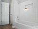 Clean white bathroom with tiled shower and white door at 2945 Christian Scott Ln, Charlotte, NC 28214