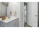 Bathroom featuring a gray vanity, large mirror, and decor at 2945 Christian Scott Ln, Charlotte, NC 28214