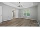 Spacious bedroom featuring hardwood floors, natural light, and a modern chandelier at 2945 Christian Scott Ln, Charlotte, NC 28214