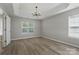 Spacious bedroom featuring hardwood floors, natural light, and a modern chandelier at 2945 Christian Scott Ln, Charlotte, NC 28214