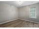This bedroom features hardwood floors and a large window providing plenty of natural light at 2945 Christian Scott Ln, Charlotte, NC 28214