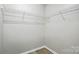 Walk-in closet featuring white wire shelving and wood flooring at 2945 Christian Scott Ln, Charlotte, NC 28214