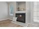 Close-up of the fireplace featuring a decorative mantel, black framed glass, and cozy decor accents at 2945 Christian Scott Ln, Charlotte, NC 28214