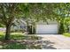 Charming single-story home featuring a two-car garage and well-manicured front yard with mature trees at 2945 Christian Scott Ln, Charlotte, NC 28214