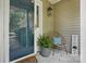 Inviting front porch featuring a stylish chair, potted plant, and welcome sign next to the front door at 2945 Christian Scott Ln, Charlotte, NC 28214
