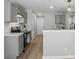 Modern kitchen with gray cabinets, marble countertops, stainless steel appliances, and luxury vinyl plank flooring at 2945 Christian Scott Ln, Charlotte, NC 28214