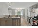 Kitchen featuring stainless steel appliances, gray cabinets, hardwood floors, and eat-in dining at 2945 Christian Scott Ln, Charlotte, NC 28214