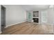 Bright living room with luxury vinyl flooring, a fireplace, and a door leading to the outdoors at 2945 Christian Scott Ln, Charlotte, NC 28214