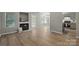 Spacious living room featuring luxury vinyl plank flooring, a fireplace, and seamless flow to the kitchen at 2945 Christian Scott Ln, Charlotte, NC 28214