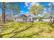Well-kept backyard with mature trees, a wooden fence, and a lush lawn, creating a peaceful and inviting outdoor space at 3002 Enderbury Dr, Indian Trail, NC 28079