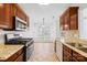 Well-lit kitchen showcasing stainless steel appliances, granite countertops, and tiled flooring at 3002 Enderbury Dr, Indian Trail, NC 28079
