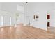 Open-concept living area with wood floors and abundant natural light at 3002 Enderbury Dr, Indian Trail, NC 28079