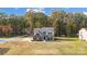 An aerial view of a beautiful gray house surrounded by trees and a large, well-maintained yard at 3018 Corinth Church Rd, Monroe, NC 28112