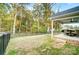 Large, partially-fenced backyard with a covered patio and mature trees at 3018 Corinth Church Rd, Monroe, NC 28112