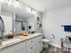 Bright bathroom featuring a double vanity, large mirror, and a shower with a glass door at 3018 Corinth Church Rd, Monroe, NC 28112