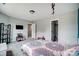 Bright bedroom with playful decor, open closet and television at 3018 Corinth Church Rd, Monroe, NC 28112