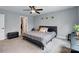 Bedroom with gray walls, ceiling fan, and decorative green plants at 3018 Corinth Church Rd, Monroe, NC 28112