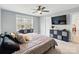 A spacious bedroom with a ceiling fan, TV, and neutral decor at 3018 Corinth Church Rd, Monroe, NC 28112