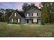 Charming two-story home featuring a brick facade and gray siding surrounded by a lush, landscaped yard at 3018 Corinth Church Rd, Monroe, NC 28112