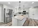 Beautiful kitchen featuring stainless steel appliances, white cabinets, a large island, and modern pendant lighting at 3018 Corinth Church Rd, Monroe, NC 28112