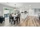 Open concept kitchen and dining area featuring stainless steel appliances, white cabinetry, and an adjacent outdoor patio at 3018 Corinth Church Rd, Monroe, NC 28112