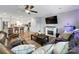 Open-concept living room with fireplace and TV, with a view of a modern kitchen featuring a center island at 3018 Corinth Church Rd, Monroe, NC 28112